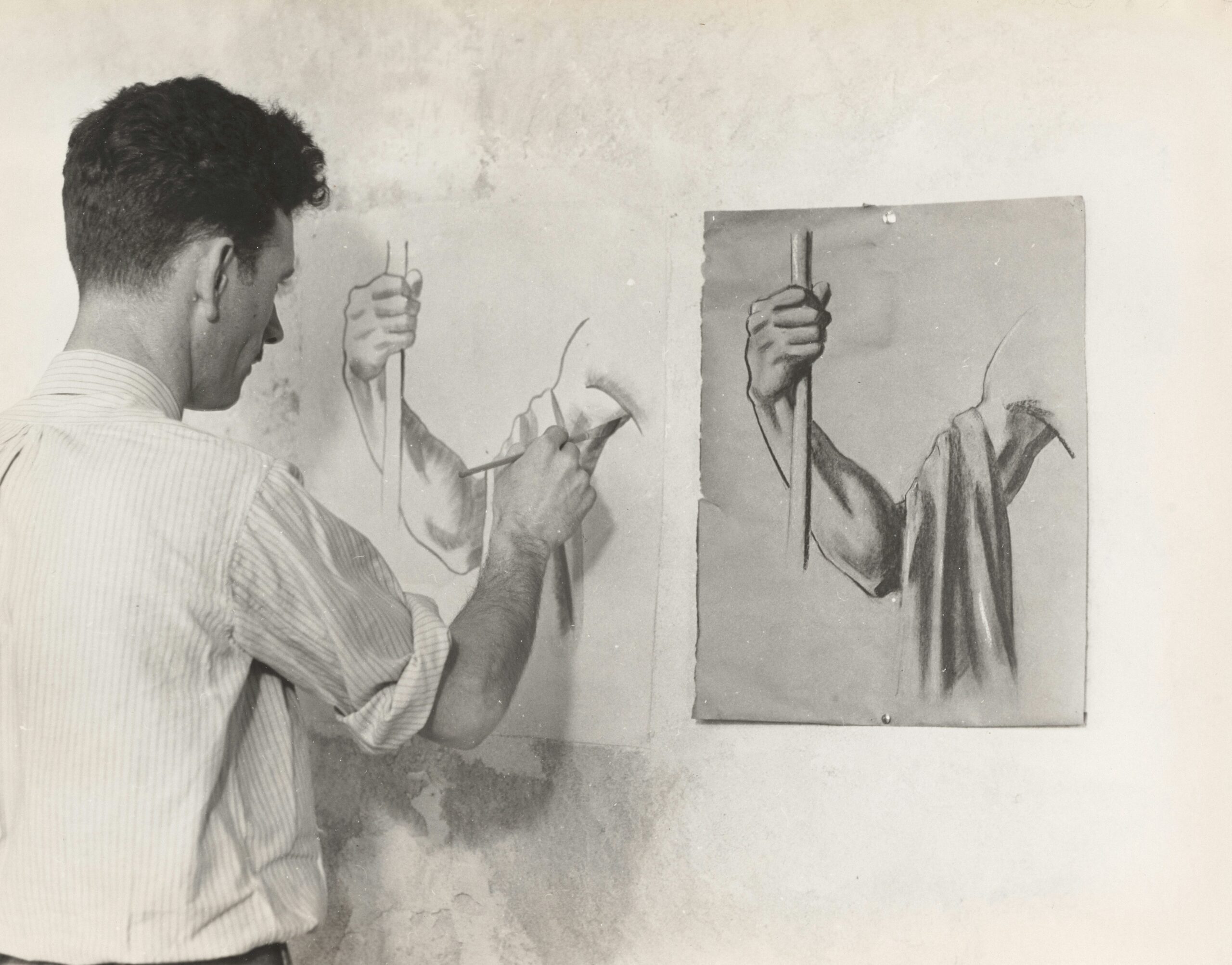 A hand holding a bristle brush demonstrating proper brushing technique